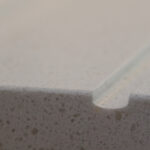 Close-up of Dover White Quartz worktop edge showing a smooth finish and fine speckled texture