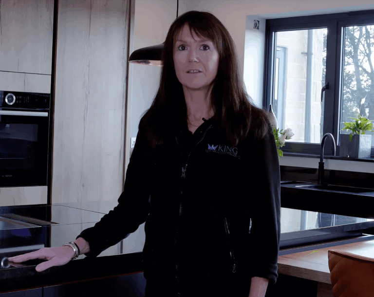 Customer testimonial video frame recorded in a modern kitchen following an Absolute Black Granite worktop installation by Mayfair Worktops.