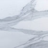 Close up of Bianco Lasa Porcelain slab showing layered grey veining across a white background