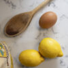 Arabescato Quartz worktop close-up with lemons and a wooden spoon showing grey veining on a white surface