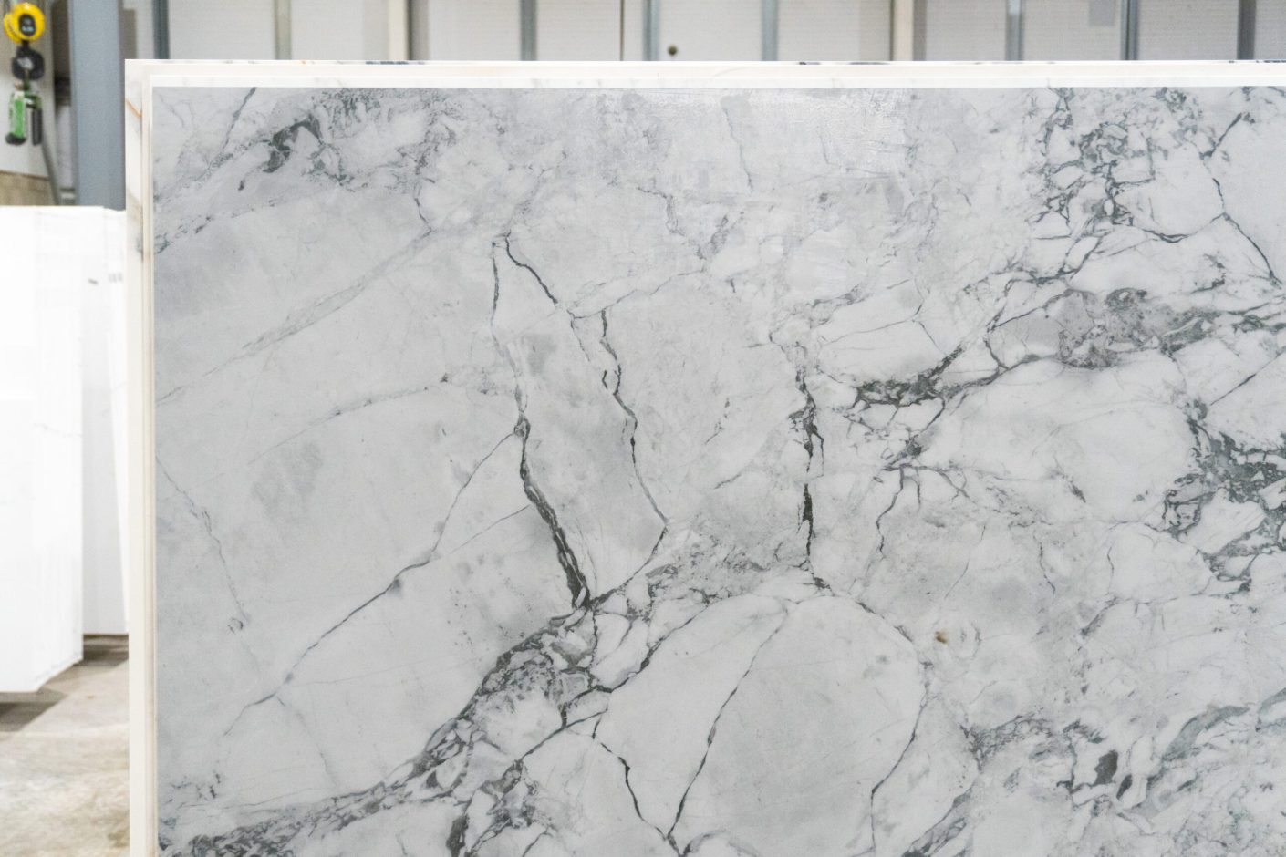 Calacatta Super White Porcelain close-up showing a white marble effect background with bold grey veining and fine hairline detail