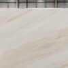 Fusion Gold Porcelain slab section showing fine warm veining and subtle cloudy movement on a light background