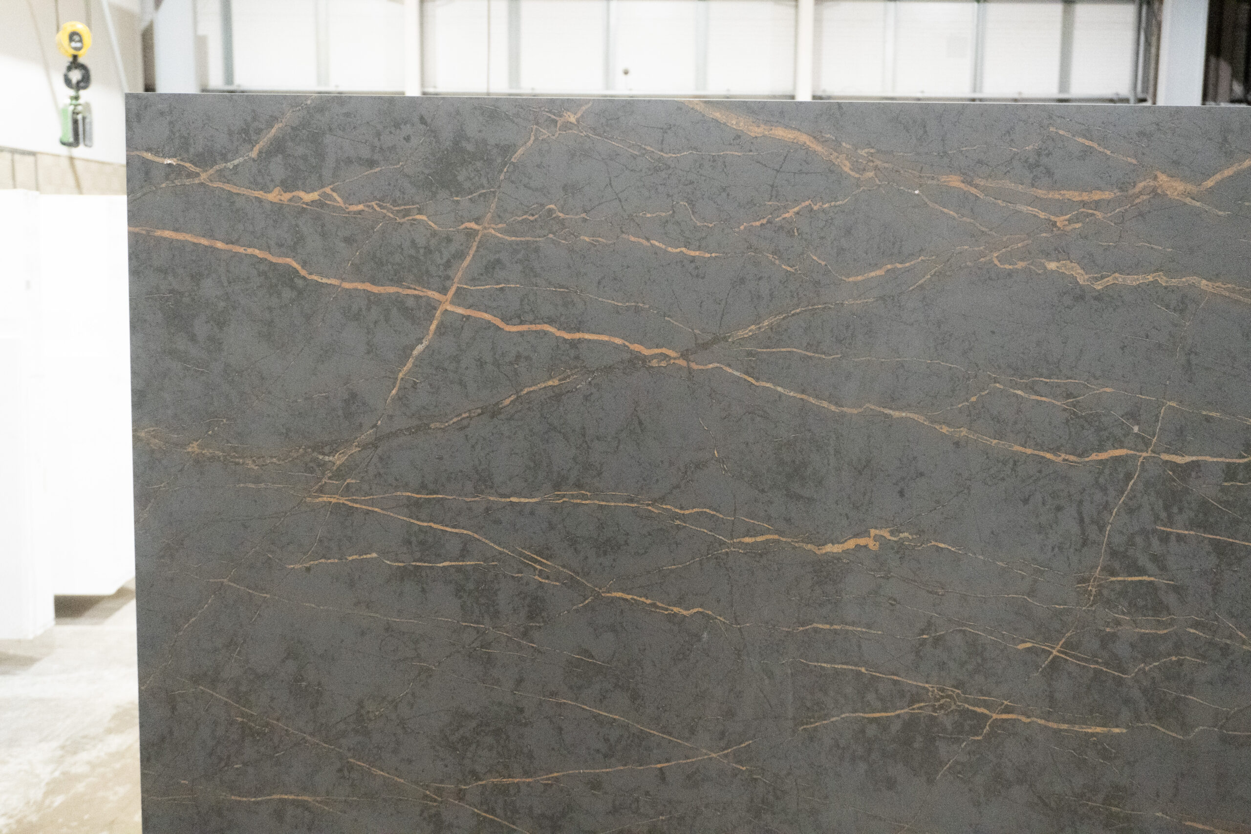 Gold Laurent Porcelain slab face showing fine gold veins spread across a dark grey surface