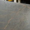 Gold Laurent Porcelain surface close-up with bold gold veining across a dark grey stone-look background