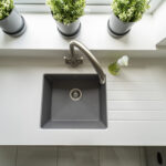 Classic White Quartz sink run with drainer grooves and an inset sink, showing a smooth white finish