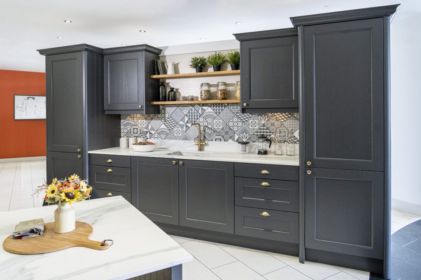 Bianco Lasa Porcelain upstand and splashback with veining above dark cabinetry and brass handles