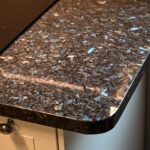 Close up of a Blue Pearl Granite worktop corner showing the rounded edge profile and shimmering blue crystal flecks in the polished surface.