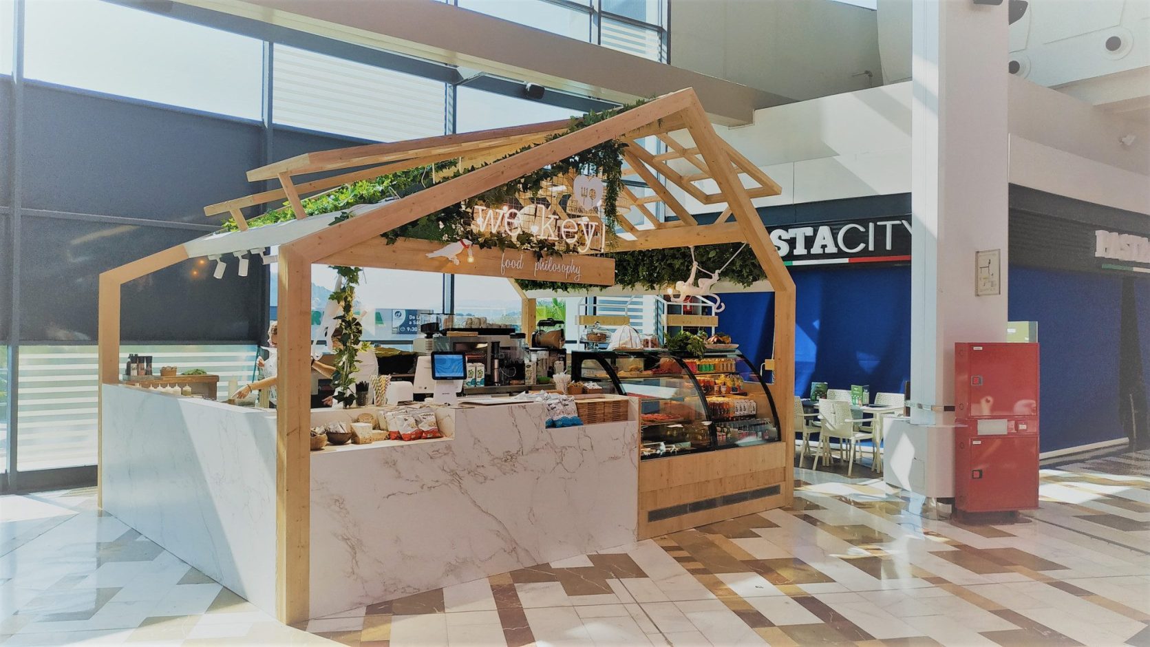 Entzo Porcelain kitchen island with marble style veining in showroom setting