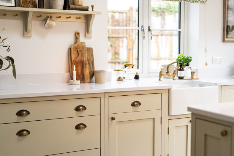 Ice White Quartz worktop along a kitchen run with light cabinetry and warm wood flooring visible