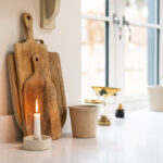 Ice White Quartz worktop by a kitchen window with chopping boards and accessories on the bright white surface