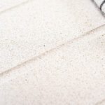Close-up of Ice White Quartz surface showing fine speckling and a smooth, uniform finish