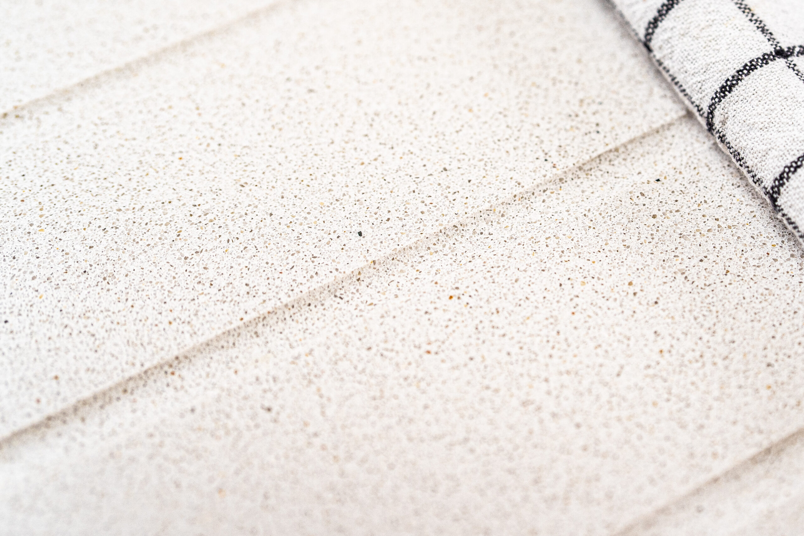 Close-up of Ice White Quartz surface showing fine speckling and a smooth, uniform finish