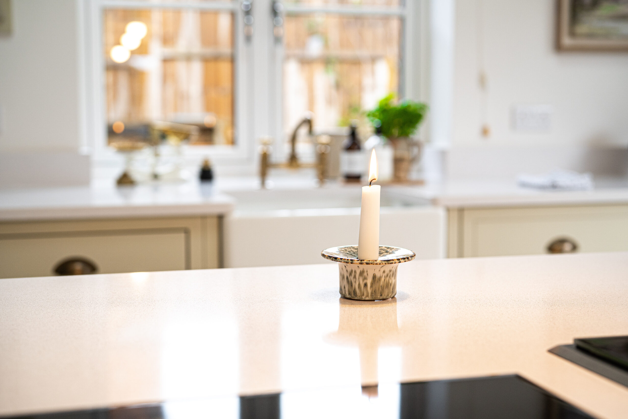 Ice White Quartz worktop surface in a bright kitchen with a smooth white finish and soft background styling
