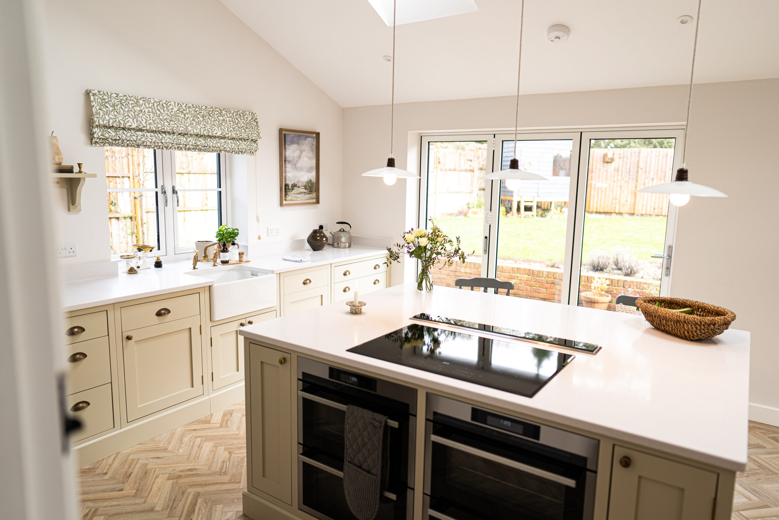 Open-plan kitchen with Ice White Quartz island worktop and pendant lighting above the bright white surface