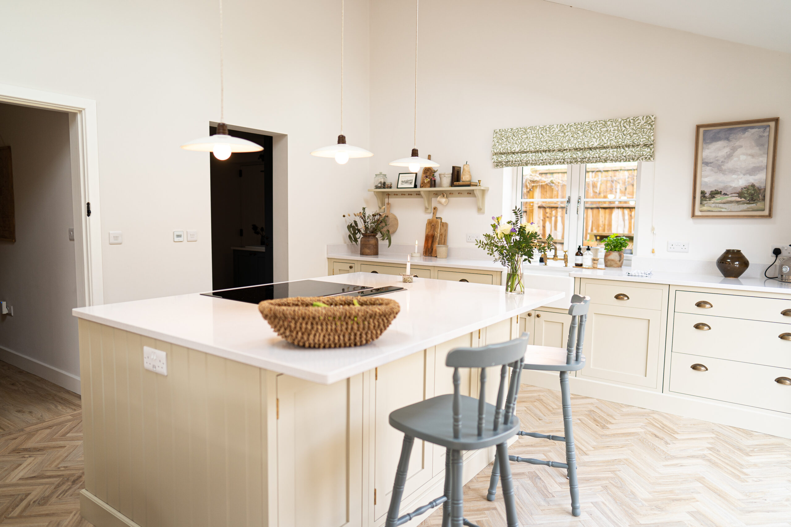Open-plan kitchen view with Ice White Quartz island worktop and seating, showing a smooth bright surface