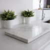 Statuario Bianco Porcelain sample on a countertop showing grey veining and clean finish
