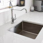 Statuario Bianco Porcelain worktops with stainless steel sink and chrome tap in a modern kitchen