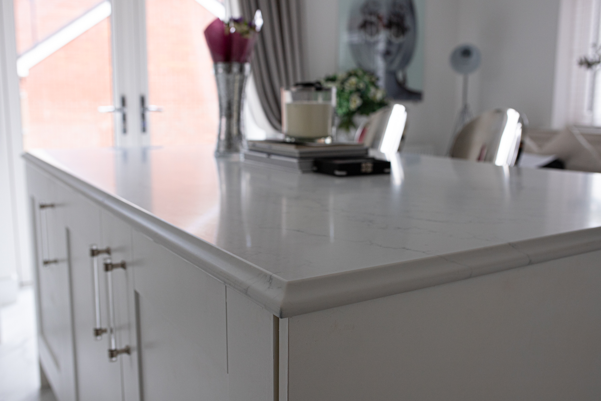 Statuario Bianco Porcelain kitchen island with subtle veining and polished edge detail