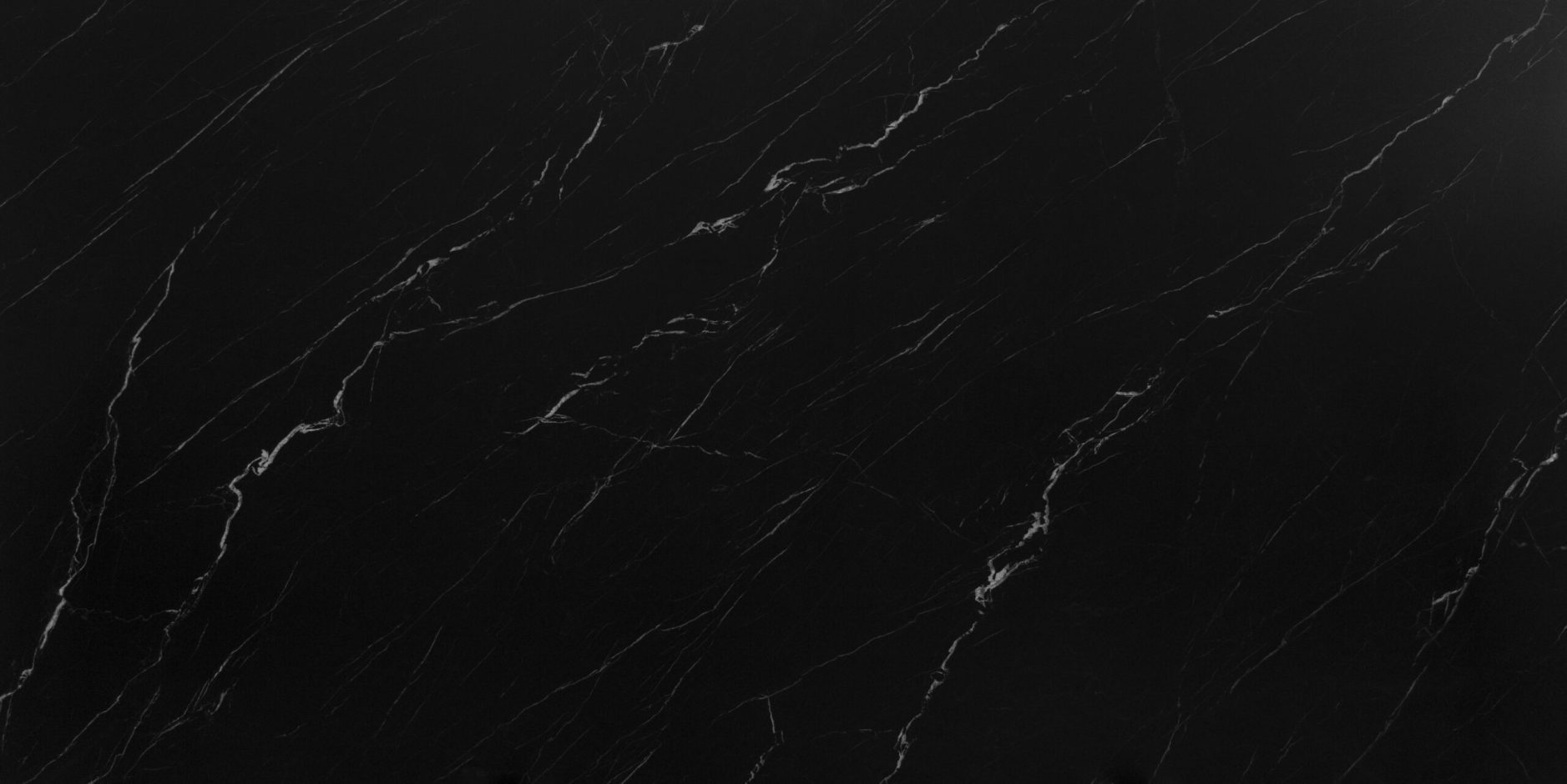 Marquina Venato Porcelain close up in deep black with soft sweeping white veining and faint secondary lines