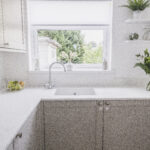 Bluetta Carrara Quartz sink run by a window showing a smooth white surface and clean finish