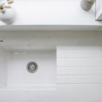 Bluetta Carrara Quartz sink area close-up showing a smooth white surface and inset sink detail