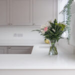 Bluetta Carrara Quartz worktop run with an undermount sink and a smooth bright white surface finish