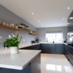 Grey Drift Quartz peninsula worktop with clean edge detail and pale stone-effect pattern in a modern kitchen