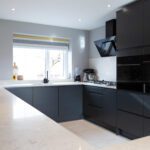 Modern kitchen with Grey Drift Quartz worktops fitted to an L-shaped run and window sink area