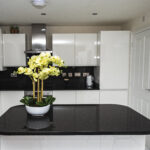 Modern kitchen with a Black Starlight Quartz island worktop showing a deep black surface with subtle sparkle