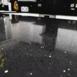 Close-up of Black Starlight Quartz worktop showing reflective sparkle flecks across a polished black surface