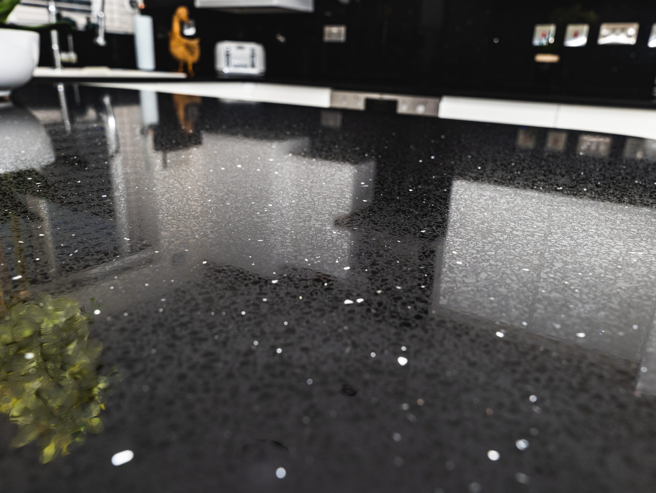 Close-up of Black Starlight Quartz worktop showing reflective sparkle flecks across a polished black surface