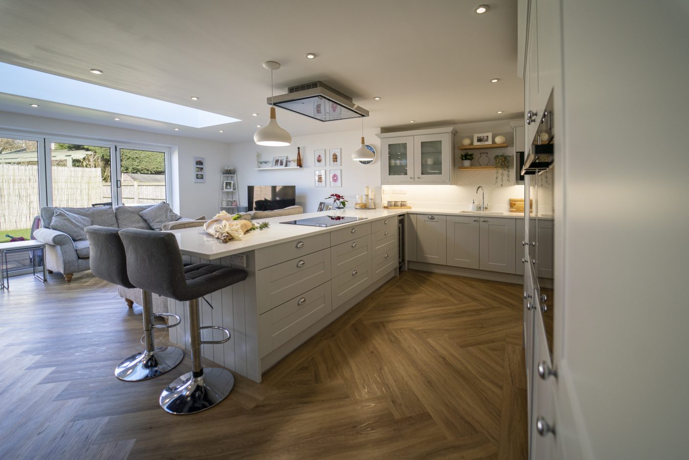 Aspen Shimmer Quartz island adjacent to a modern living area