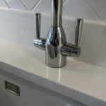 Chrome tap fitted onto Aspen Shimmer Quartz worktops in a modern kitchen