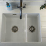 Top view of a white double sink set into Aspen Shimmer Quartz worktops
