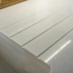 Close up of Aspen Shimmer Quartz drainer grooves with polished finish