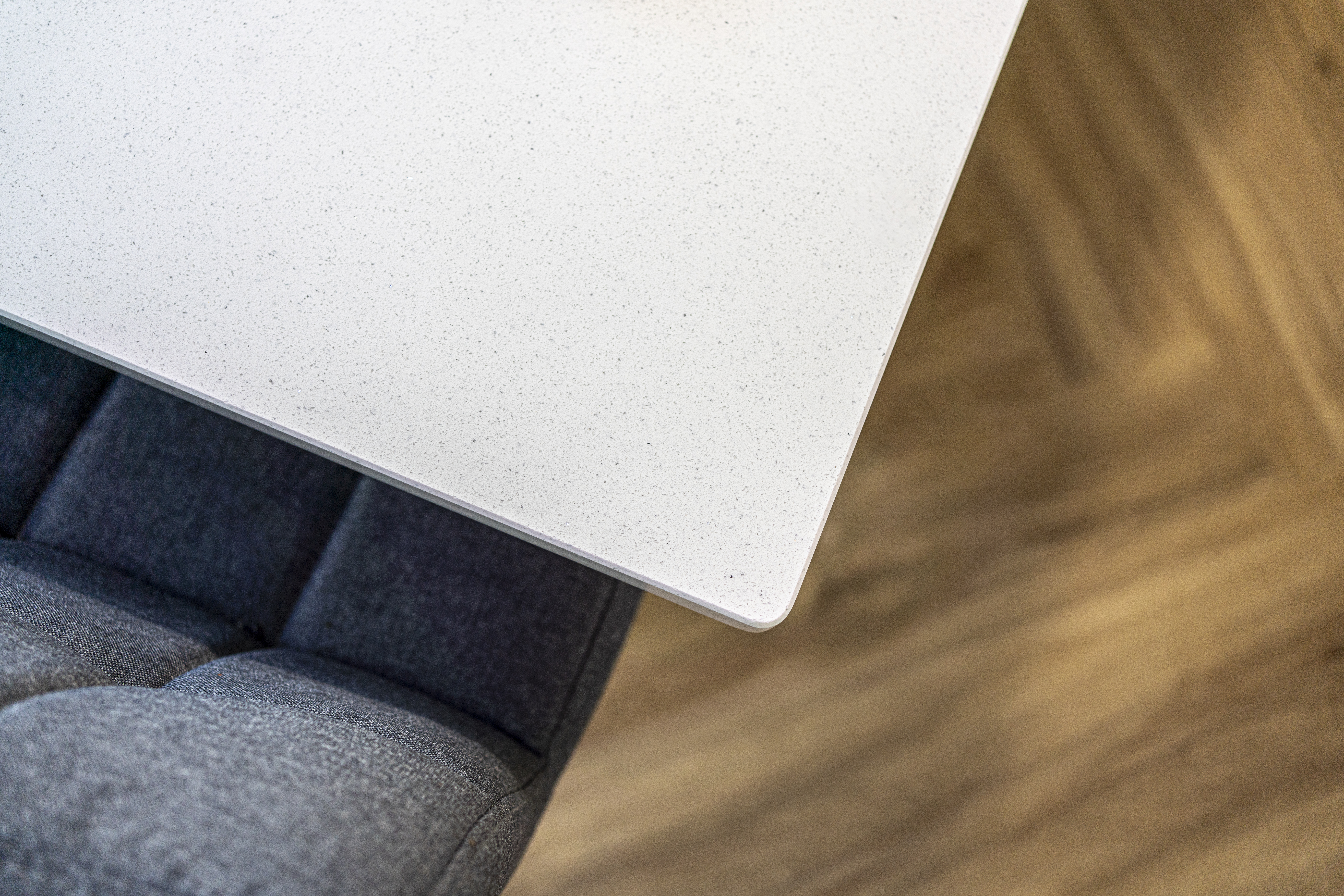 Aspen Shimmer Quartz worktop edge above upholstered seating in a modern kitchen