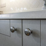 Aspen Shimmer Quartz worktop above grey cabinetry with chrome handles