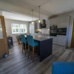 Open plan kitchen featuring White Starlight Quartz island and modern seating