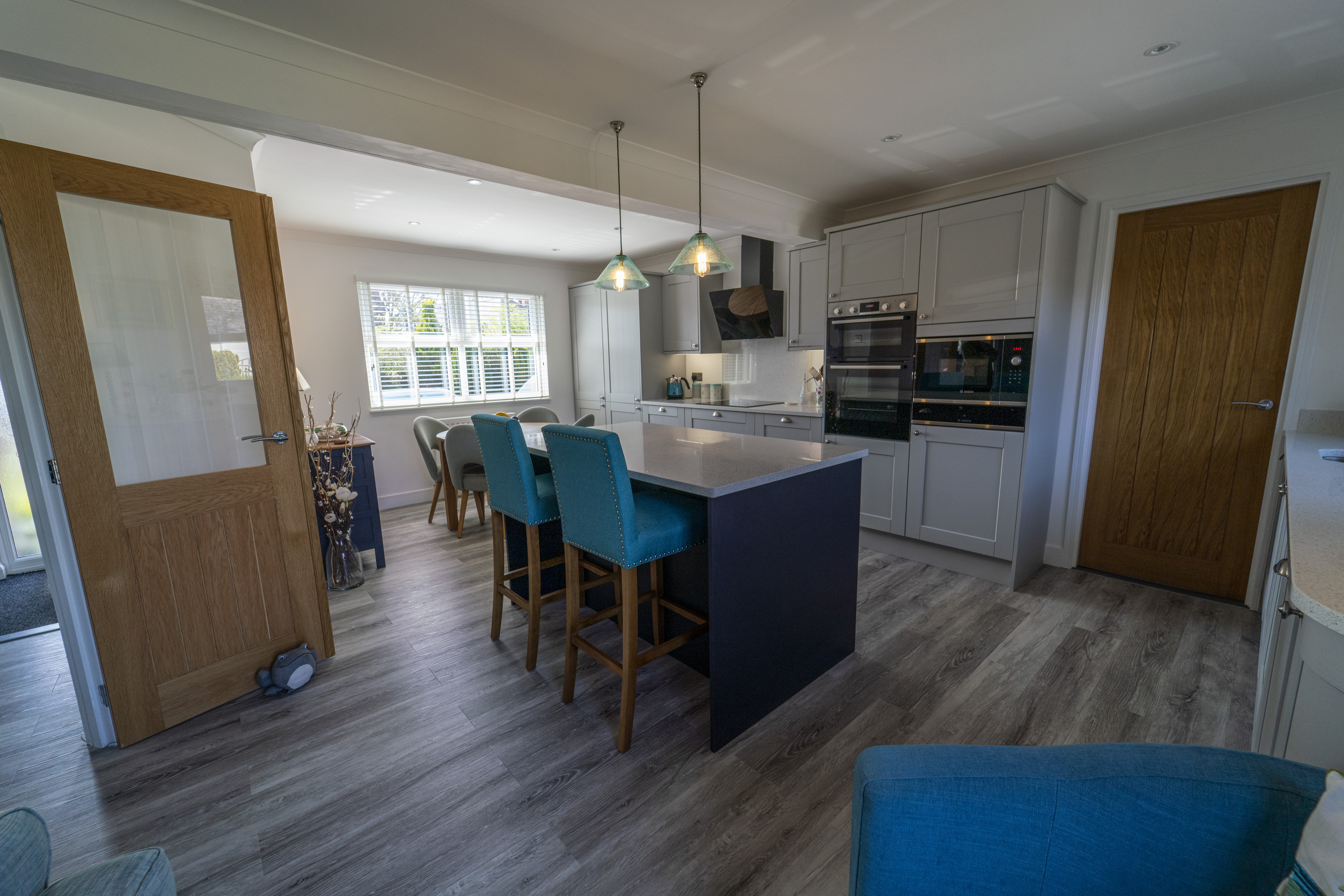 Open plan kitchen featuring White Starlight Quartz island and modern seating