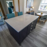 White Starlight Quartz island corner in a modern kitchen with blue seating