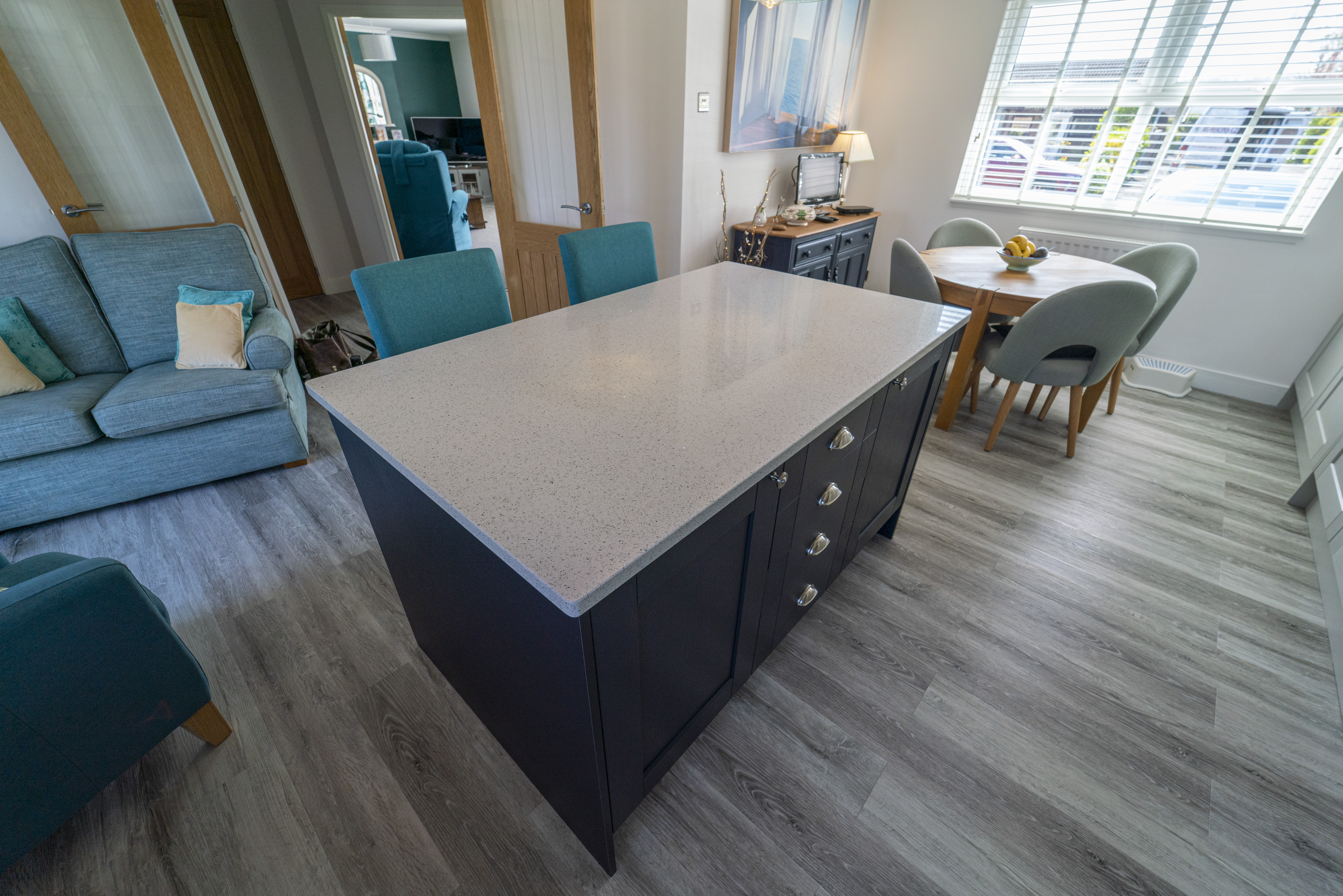 White Starlight Quartz island corner in a modern kitchen with blue seating