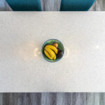 White Starlight Quartz worktop surface styled with fruit in a bright kitchen setting