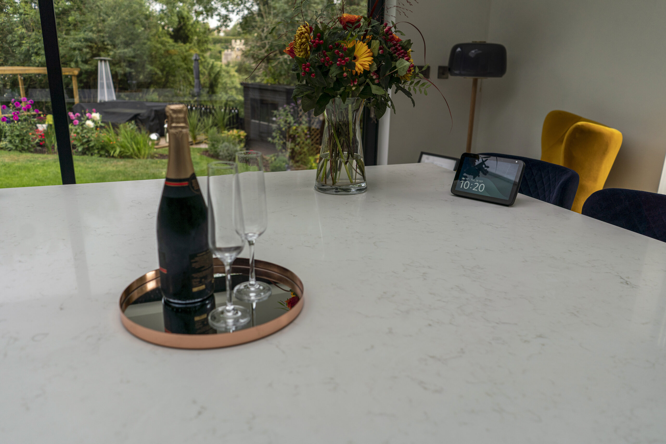 Drinks setup on Carrara Quartz worktop with bottle and glasses