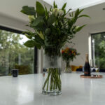 Carrara Quartz worktop beside large window with flower vase