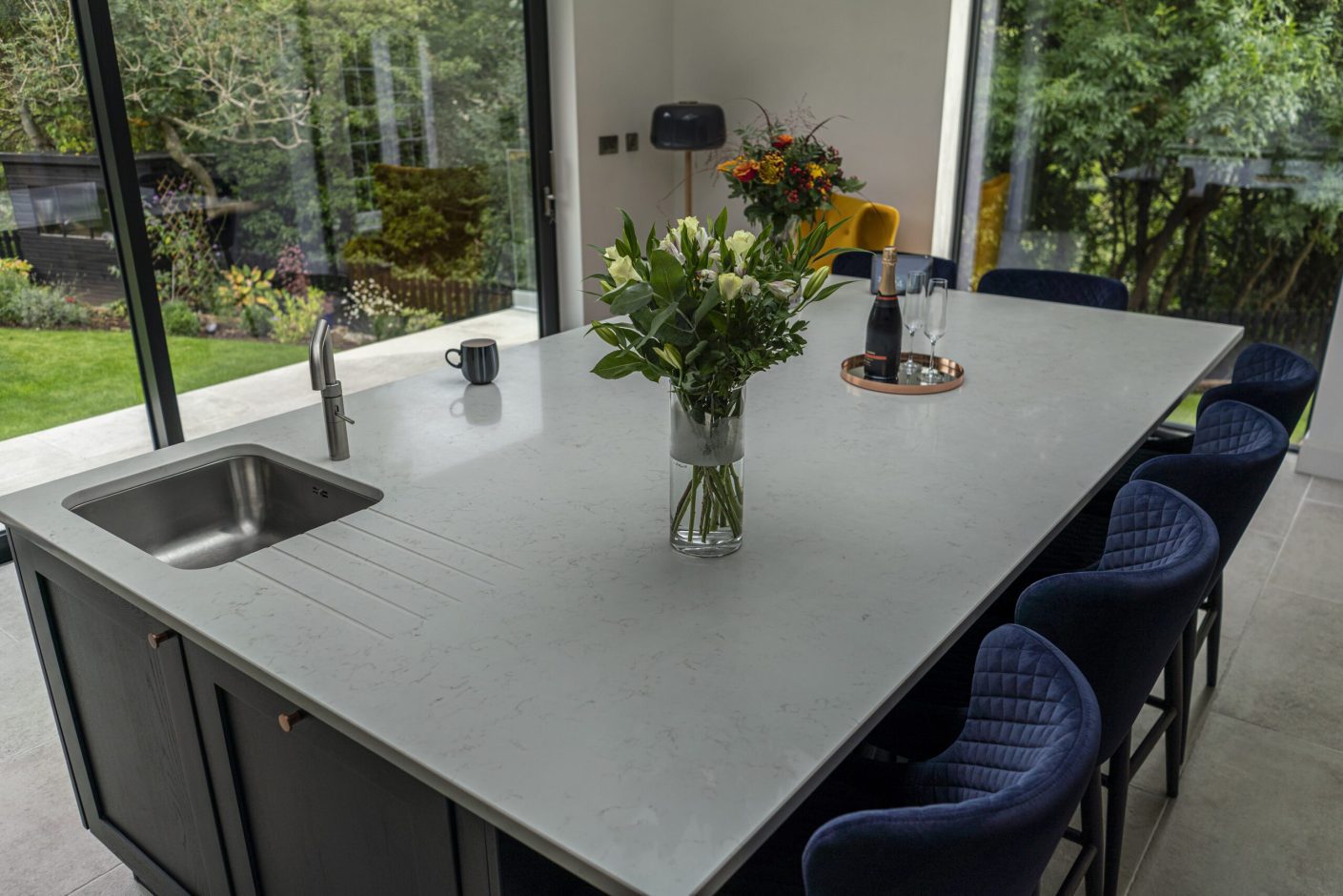 Carrara Quartz worktop beside large window with flower vase