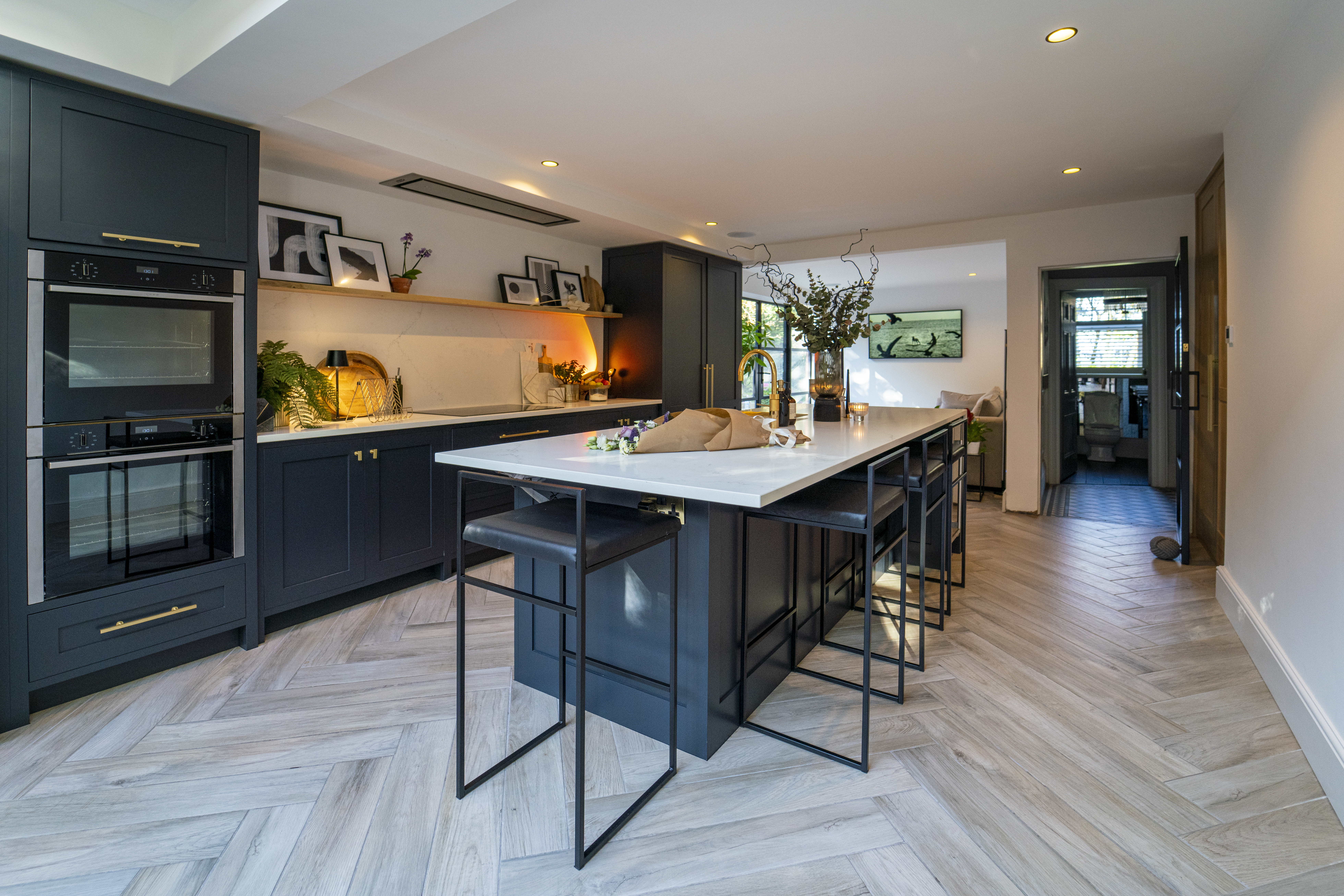Wide view of a modern kitchen featuring an Olympus White Quartz island with subtle grey veining