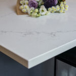 Olympus White Quartz worktop corner close-up with soft grey veining across a bright white finish