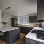 Kitchen island and cooking area finished with Imperial White Quartz worktops and a gas hob