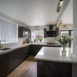 Bright kitchen view showing an Imperial White Quartz island worktop with a clean, smooth surface