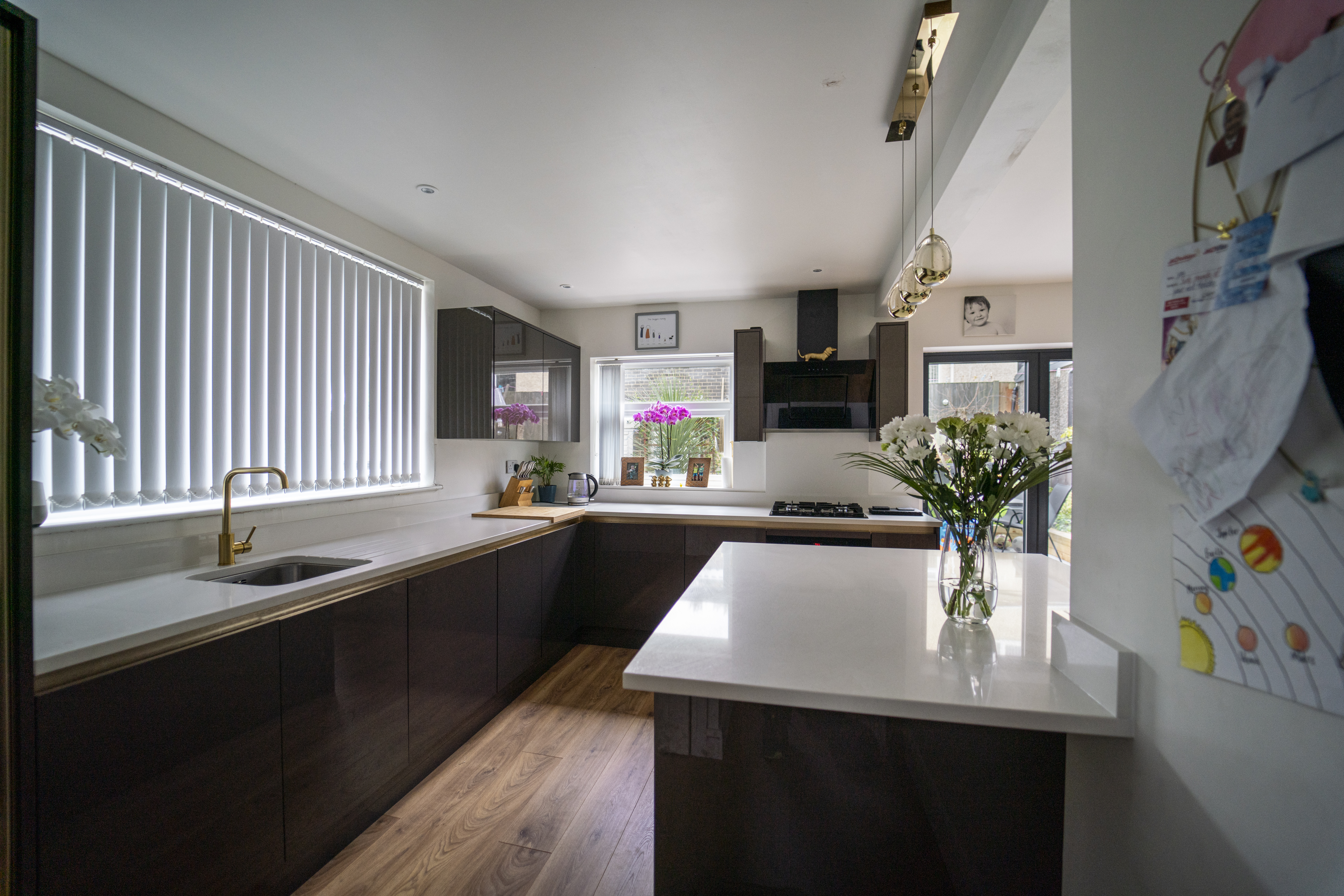 Bright kitchen view showing an Imperial White Quartz island worktop with a clean, smooth surface
